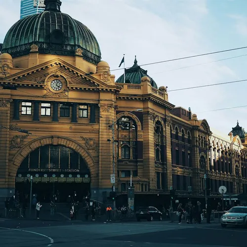 A Melbourne street with traffic passing brick buildings